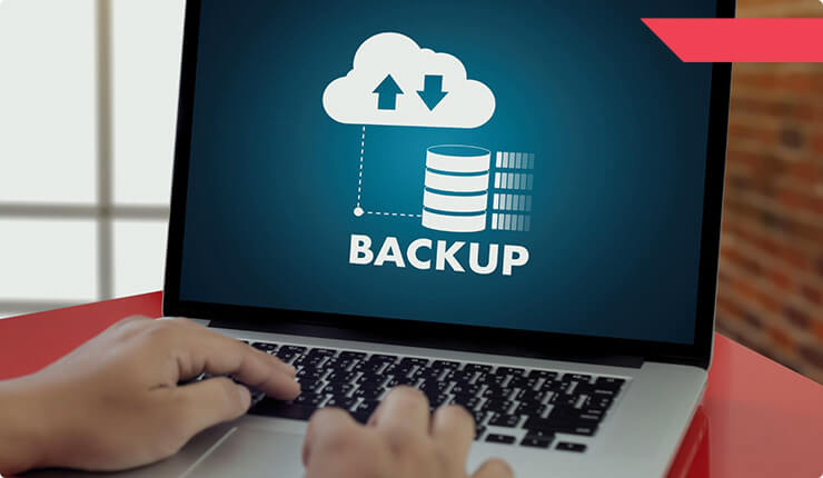 An IT professional setting up data backup and recovery to prevent loss of data